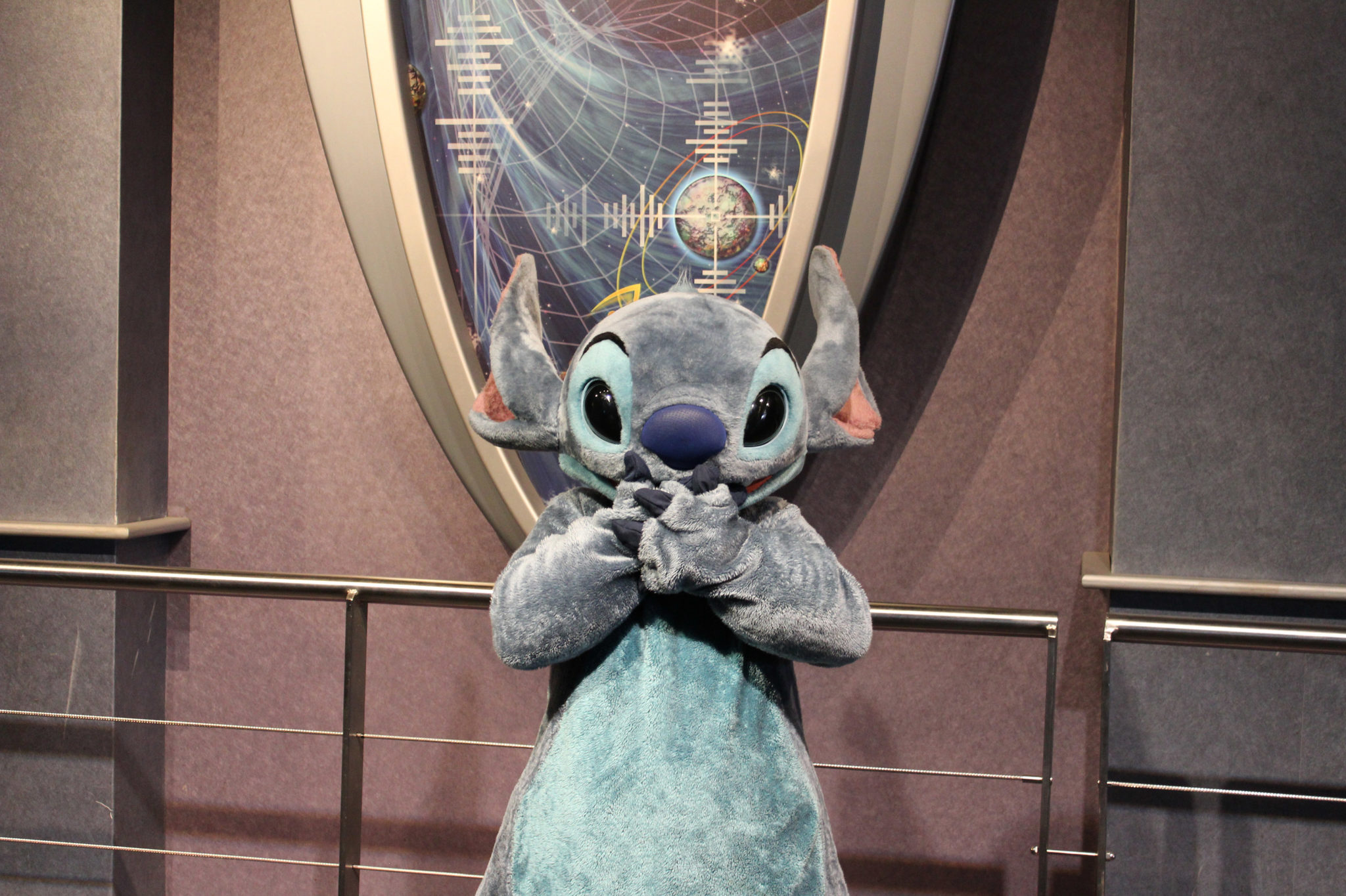 Stitch covering his mouth with his hands.
