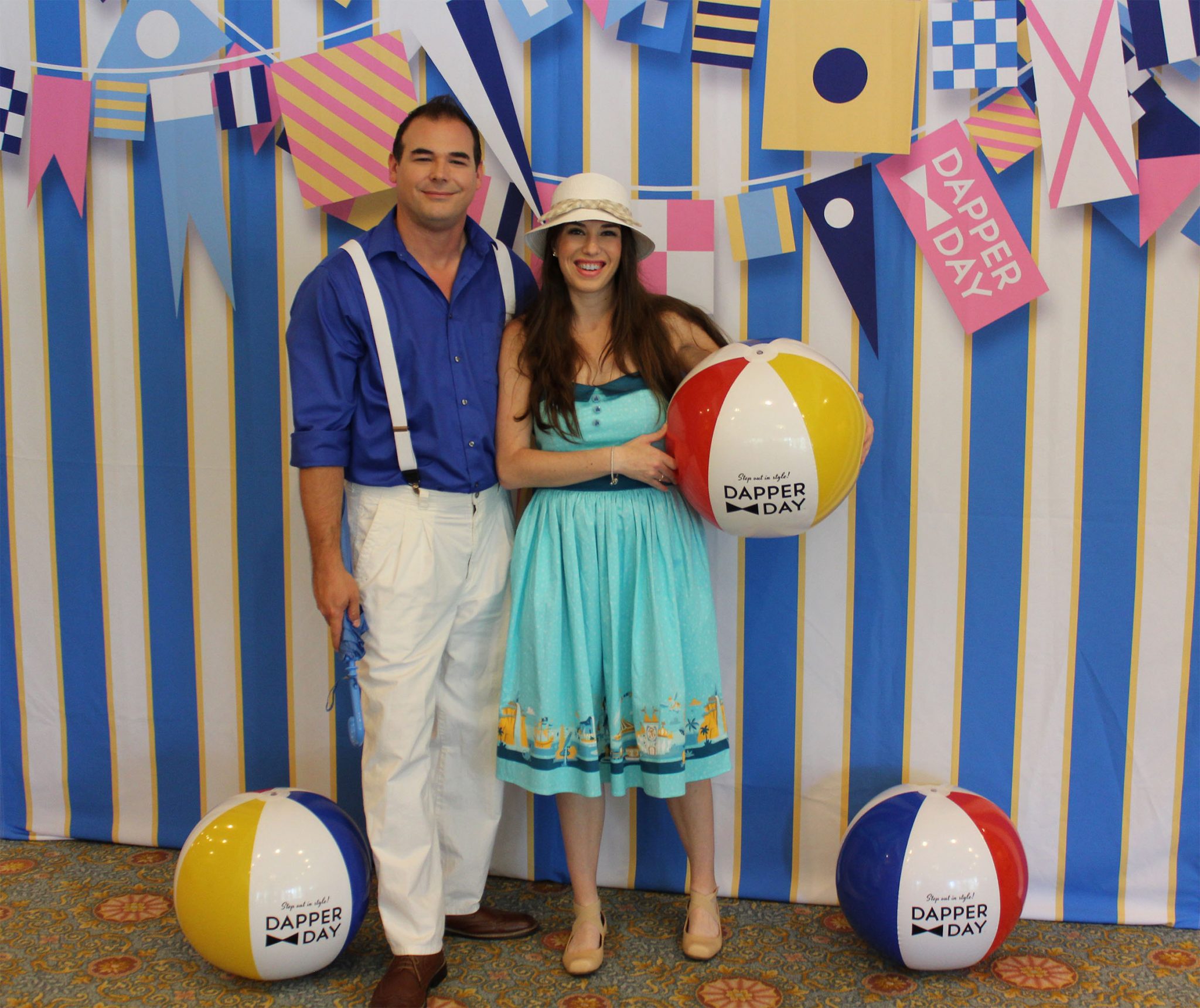 Chelsea and Jay with the official Dapper Day photo backdrop.