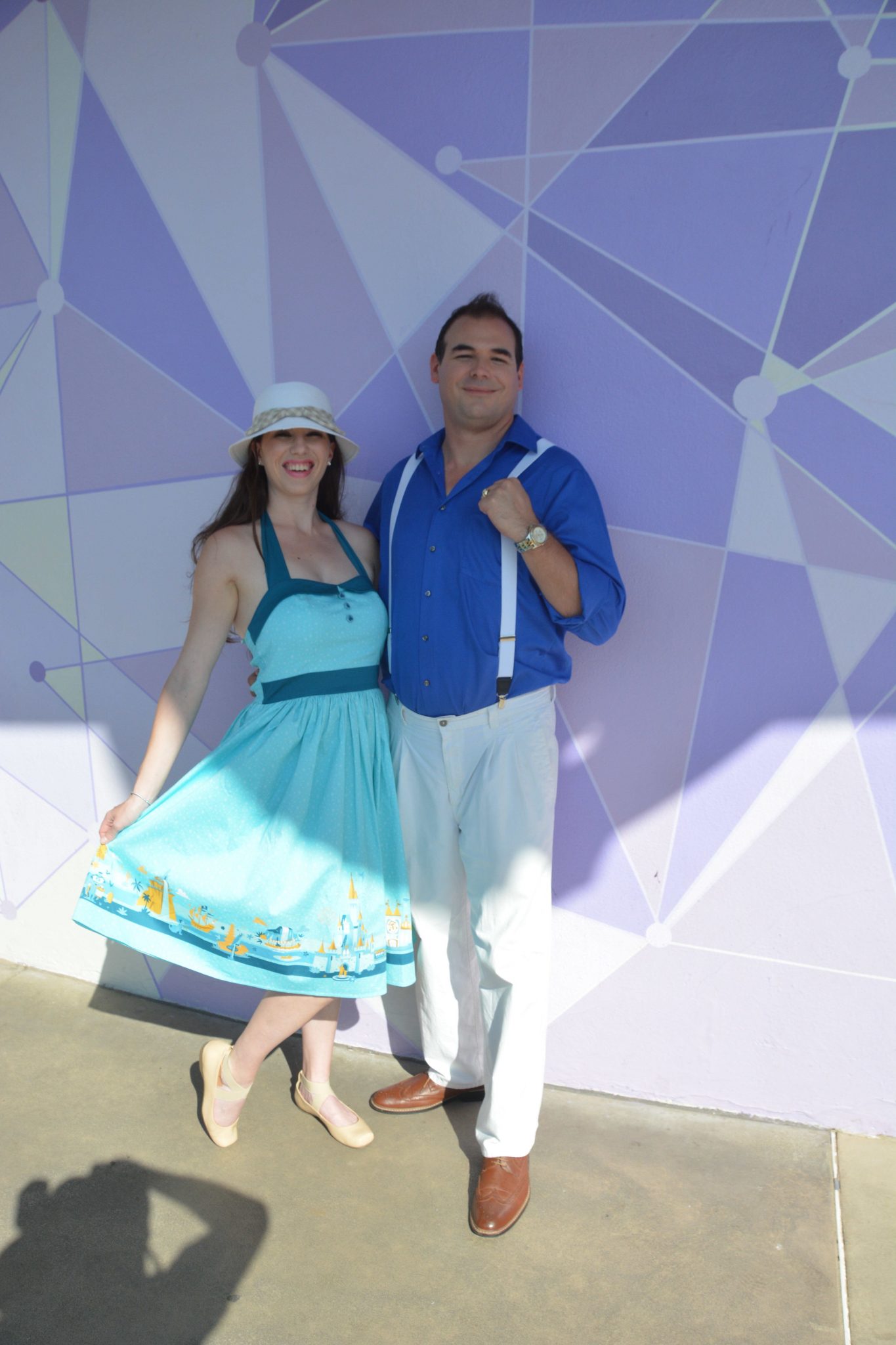 Chelsea and Jay being adorable in front of Magic Kingdom's Purple Wall on Dapper Day.
