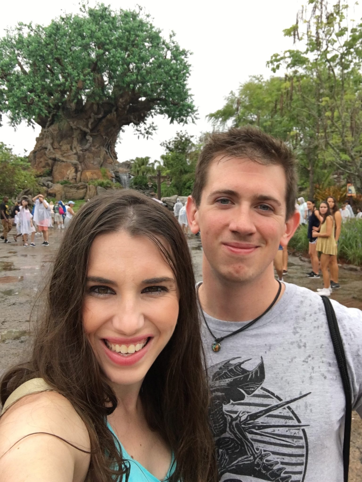 Chelsea and Robby in front of the Tree of Life in the rain.