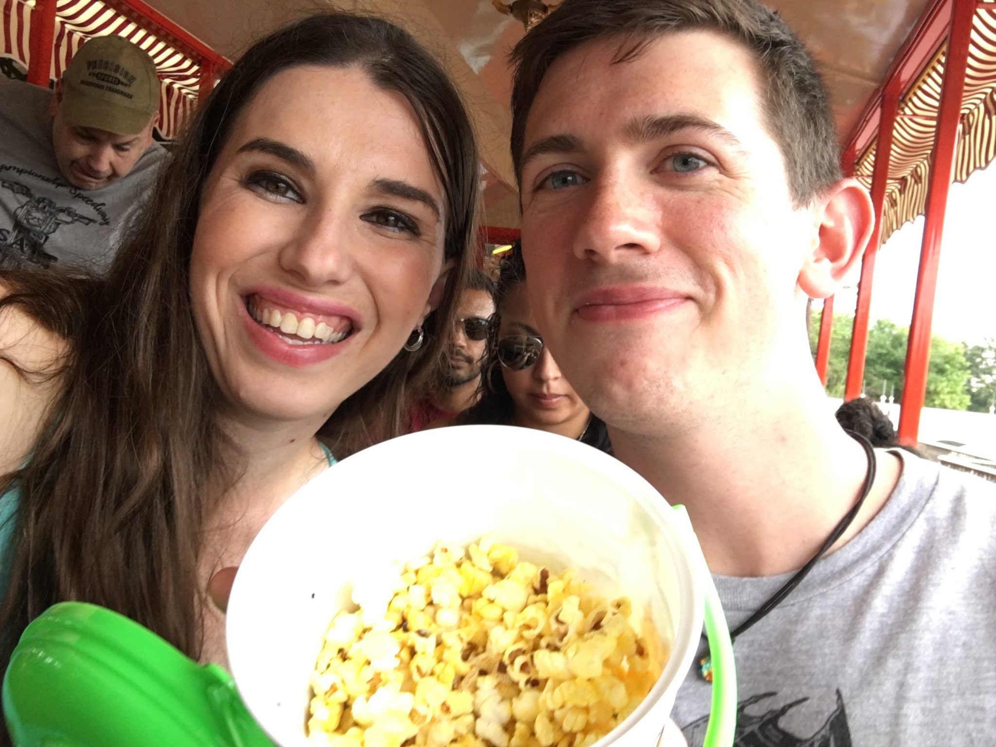 Chelsea and Robby on the Magic Kingdom train with Disney popcorn.