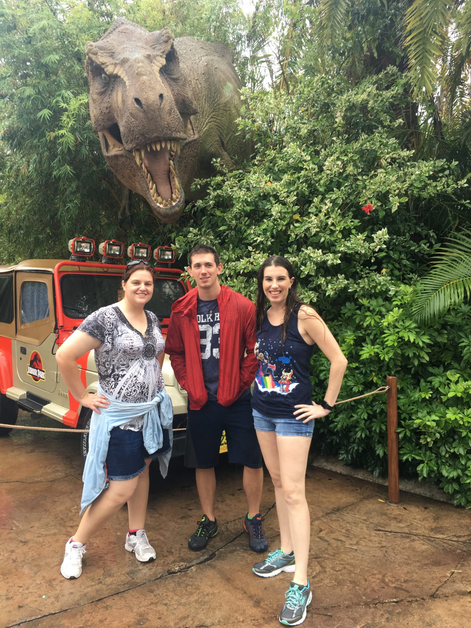 Lacey, Robby, and Chelsea in Jurassic Park in the rain.