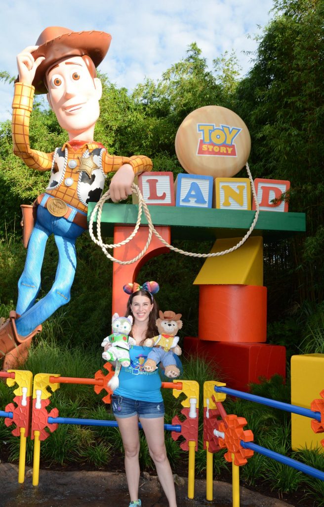 Chelsea and Duffy in front of Woody and the Toy Story Land sign.