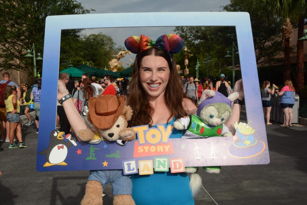 Chelsea posing with the Toy Story Land Photopass frame.