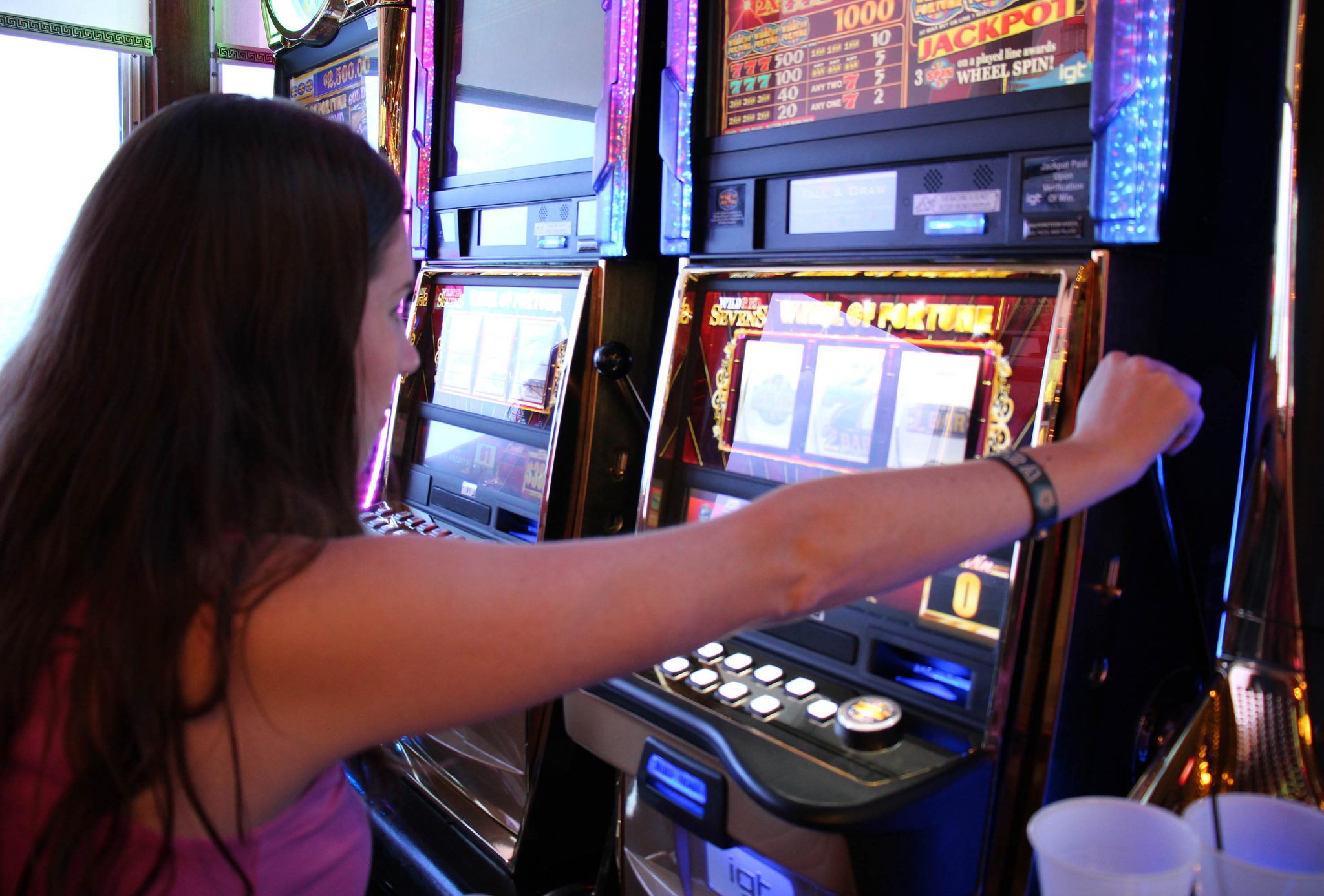 Chelsea at a slot machine on the Victory Casino Cruises.
